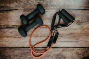 Adults perform body-weight squats and brisk walking exercises in a bright community fitness setting.