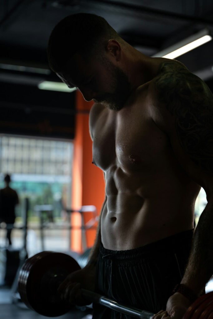 Person reviewing a fitness journal beside resistance bands and a water bottle after an indoor workout.